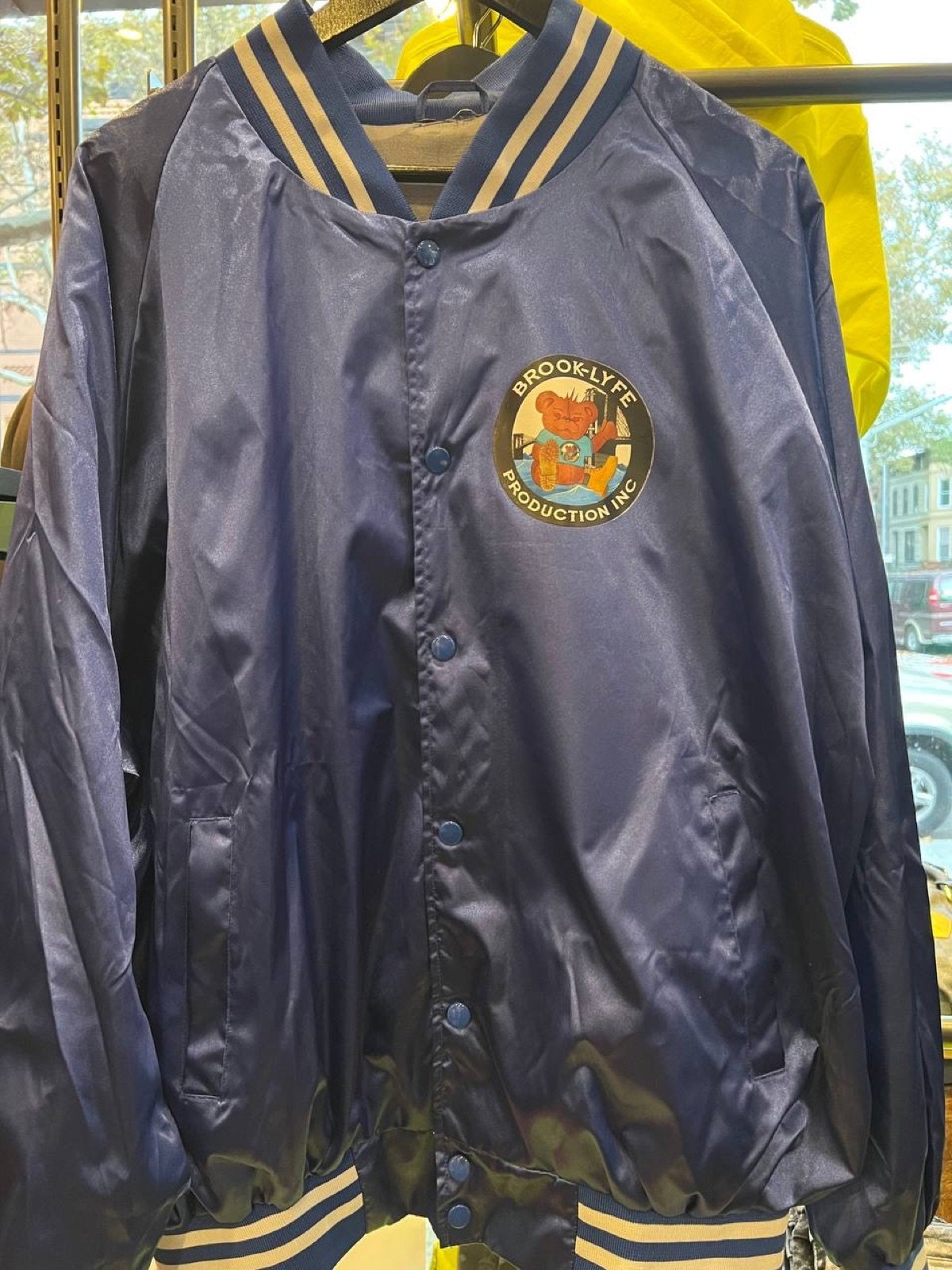 Front of navy Brook-Lyfe satin varsity jacket