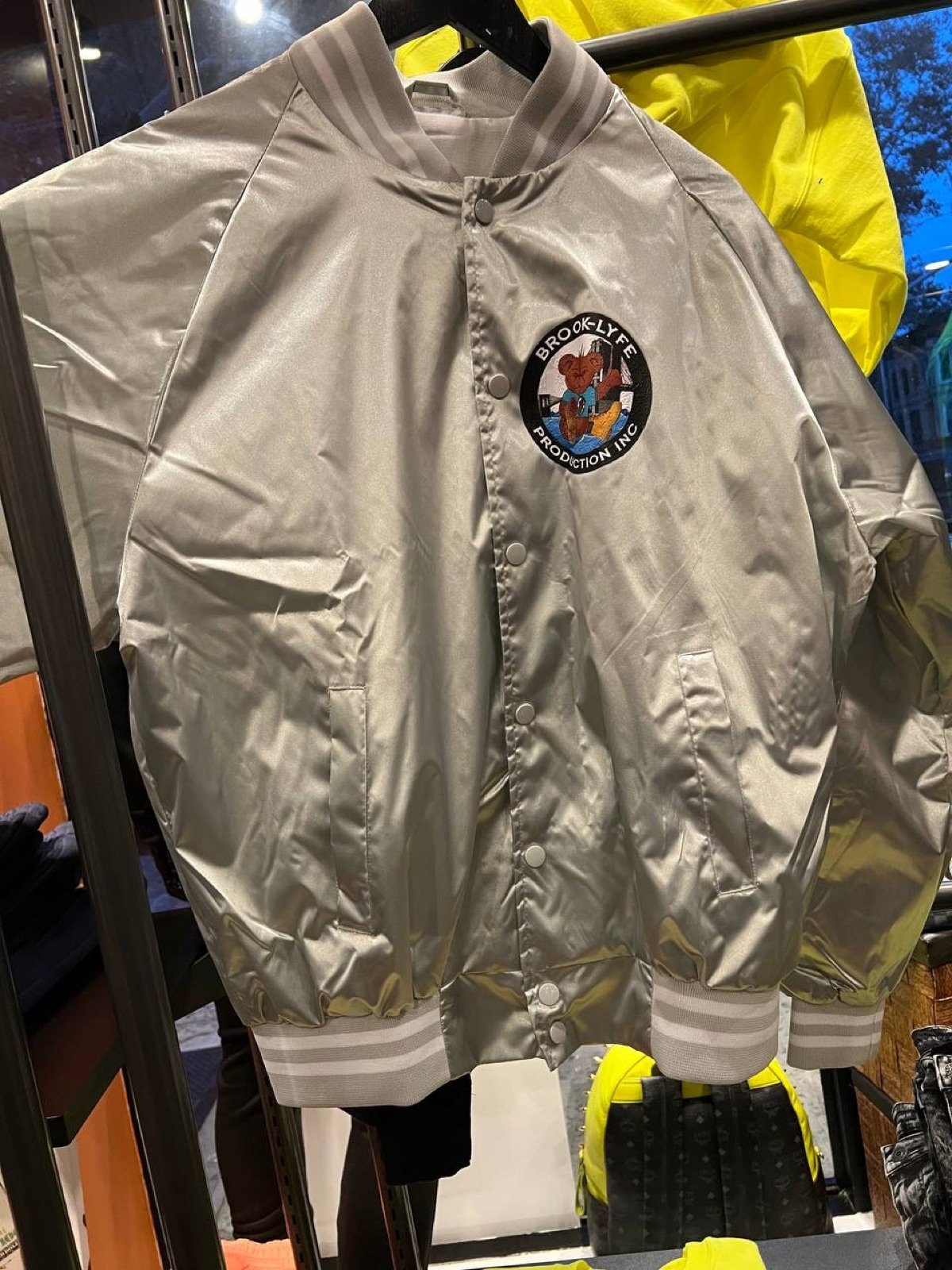 Front of silver Brook-Lyfe satin varsity jacket